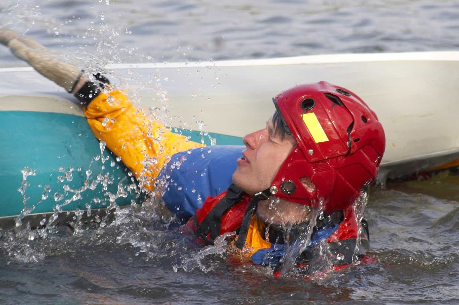 Falling and entering a kayak from the water